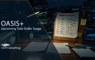 Still-life of a federal office desk at night with ‘Task Order’ envelopes, multi-domain project materials, and a laptop trend chart, signaling an imminent surge in OASIS+ task orders.