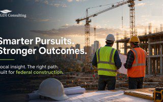 Construction managers reviewing plans on a federal construction site during sunset, representing bid review and local project evaluation.