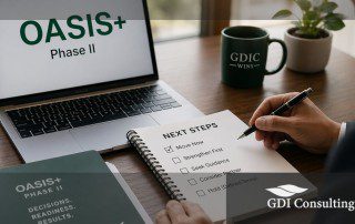 Professional office desk scene showing a laptop with “OASIS+ Phase II” on screen, a person reviewing a “Next Steps” checklist, and a notebook about decision readiness, with a GDIC mug and GDI Consulting logo overlay.