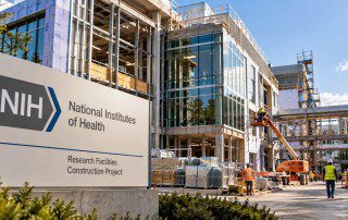 AI-generated illustration of NIH-branded research facility construction, showing an unfinished building, workers, and scaffolding